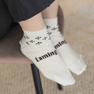 Woman wearing Lamington merino ankle socks in cream with rust and brown pattern made in New Zealand.
