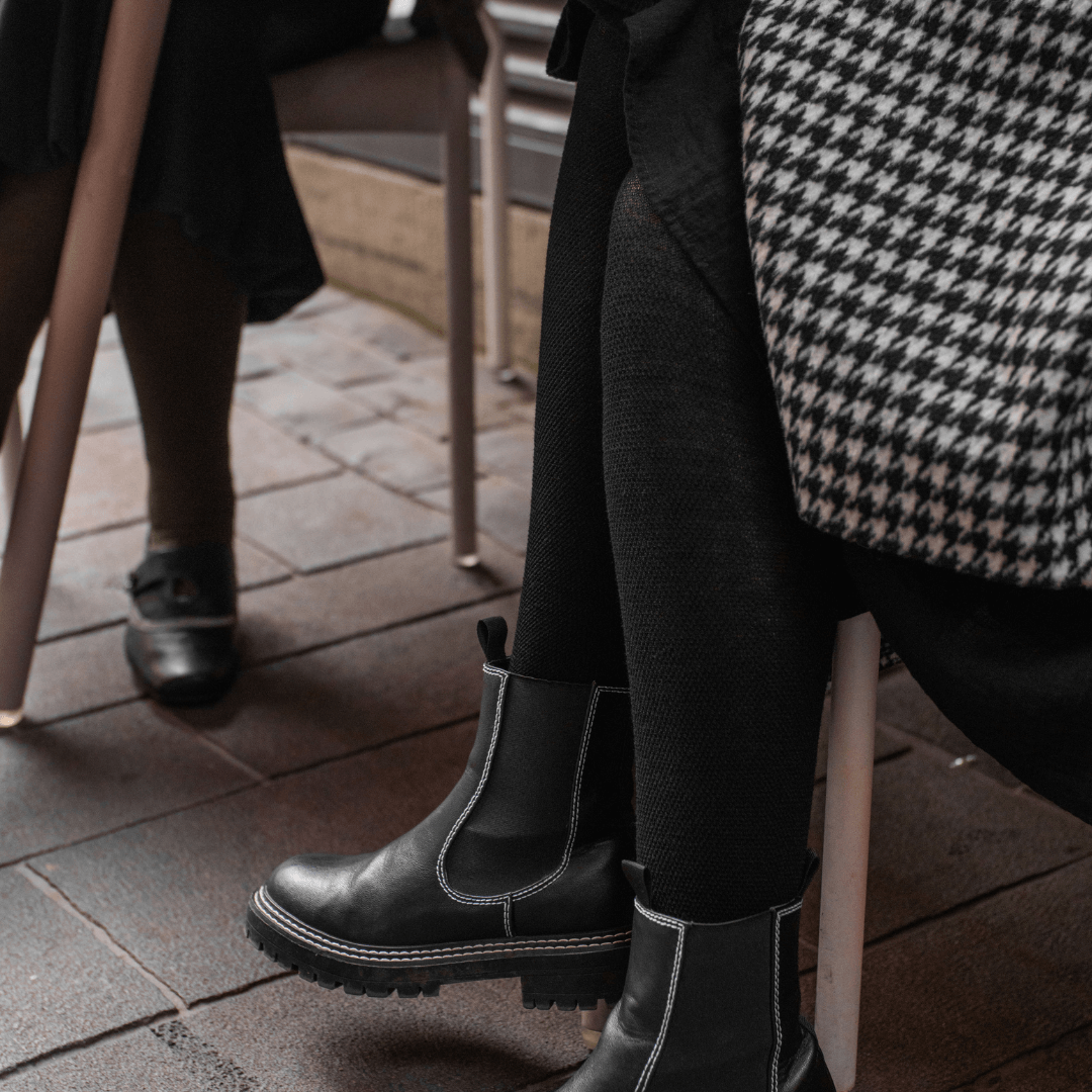 Merino Wool Textured Knit Tights worn by a woman, showcasing a stylish silhouette in black.